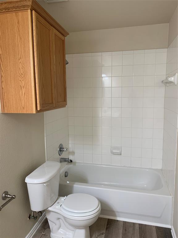 12226 Peak Circle Frisco, TX 75035 - Photo 22 of 27 a white toilet sitting next to a bath tub