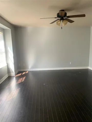 a view of storage and utility room with wooden floor and cabinet