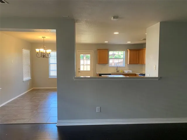a view of kitchen with cabinets and wooden floor
