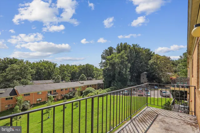 a view of a balcony with wooden fence