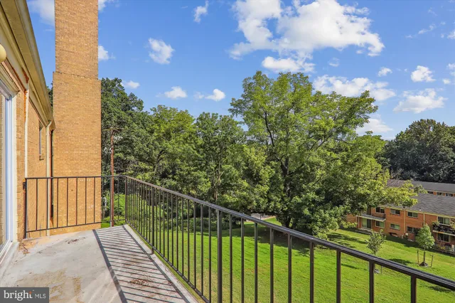 a view of a balcony with wooden fence