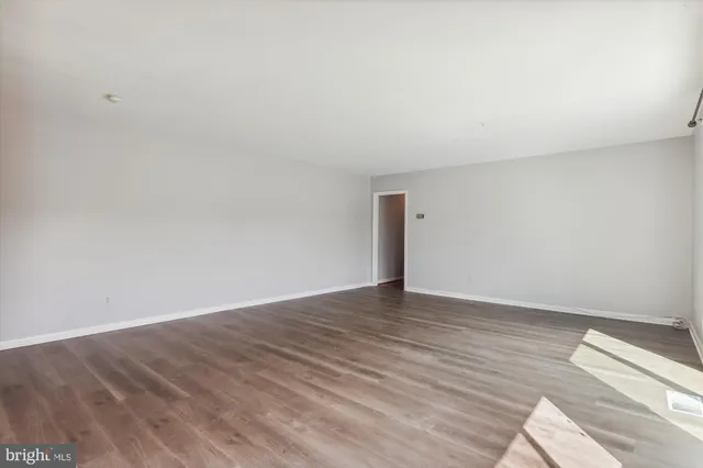 a view of an empty room and wooden floor