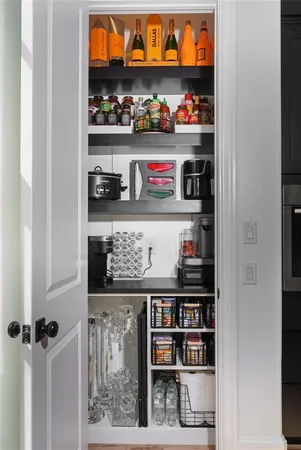 a cabinet with granite countertop lots of different kinds of food