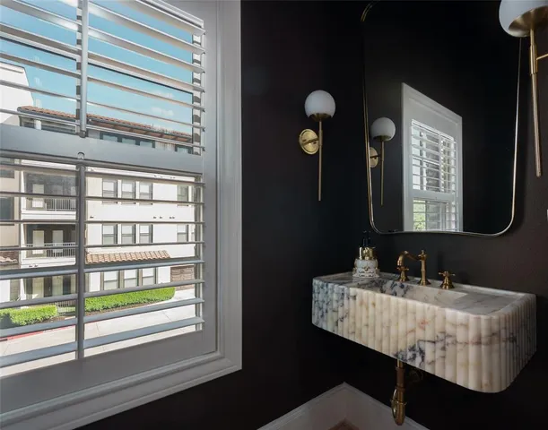 a bathroom with a mirror and a sink