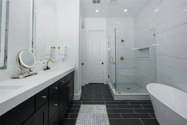 a bathroom with a sink a toilet a mirror and shower