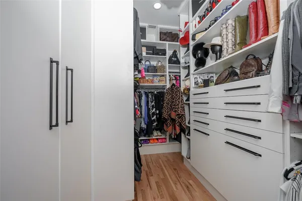 a view of walk in closet with clothes