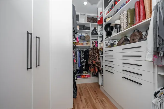 a view of walk in closet with clothes