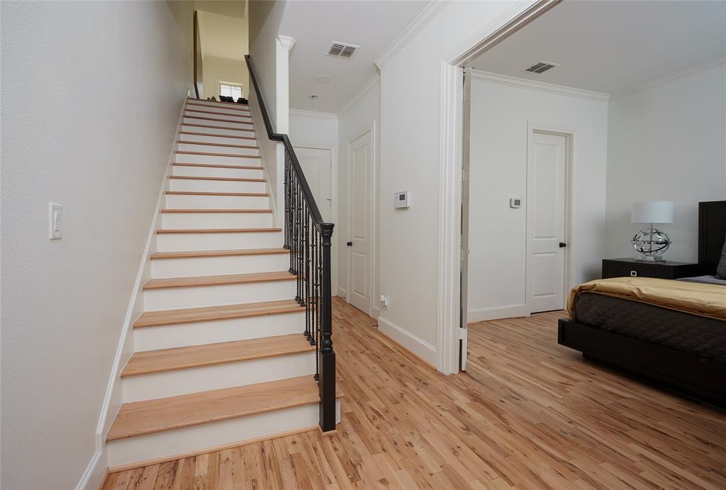 727 Will Rice Avenue Irving, TX 75039 - Photo 24 of 26 a view of a bedroom with wooden floor and stairs