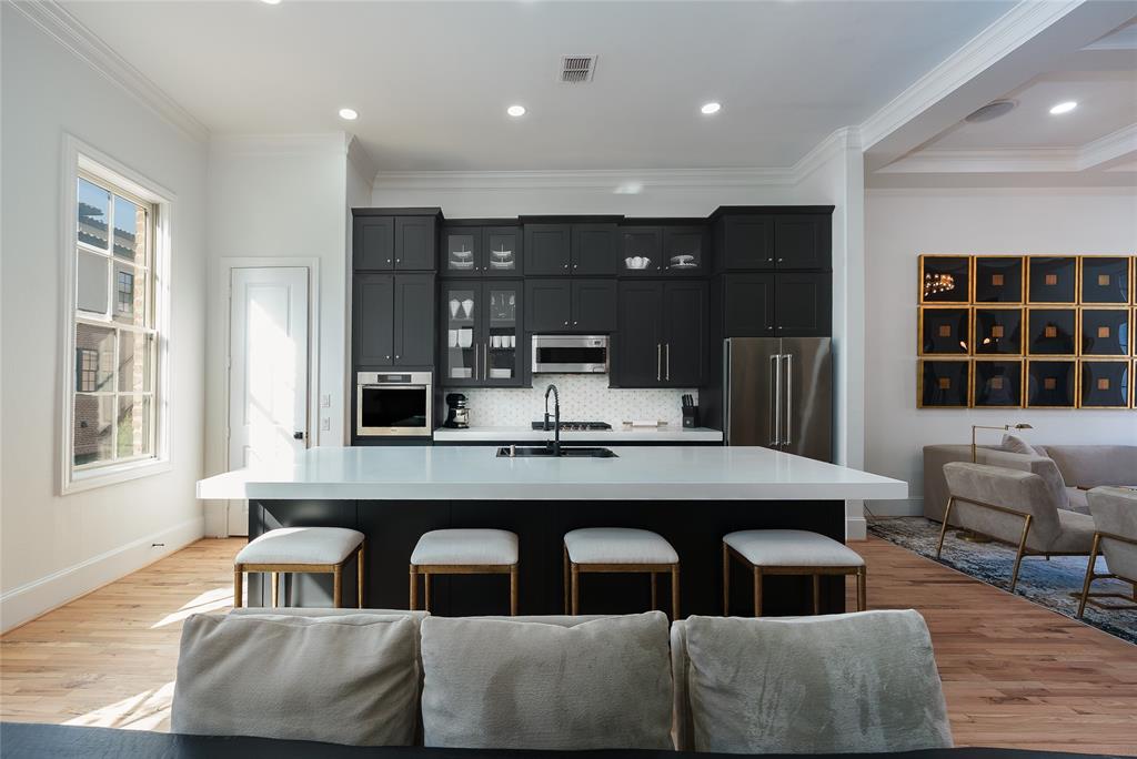 727 Will Rice Avenue Irving, TX 75039 - Photo 3 of 26 a dining hall with couches a flat tv screen and a dining table with wooden floor