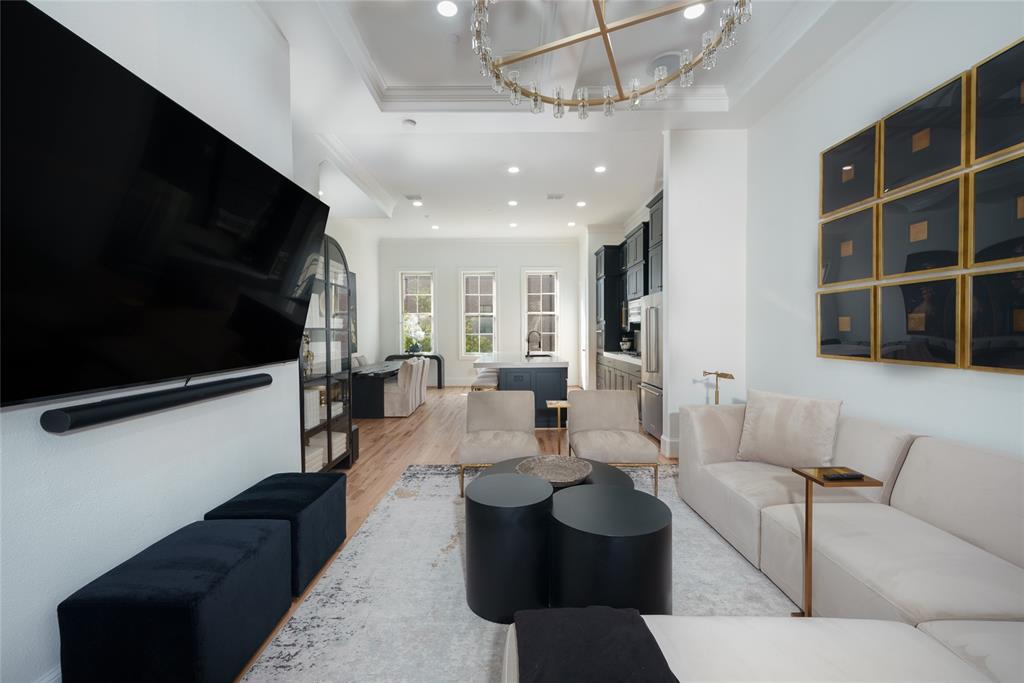 727 Will Rice Avenue Irving, TX 75039 - Photo 5 of 26 a living room with furniture a flat screen tv and kitchen view