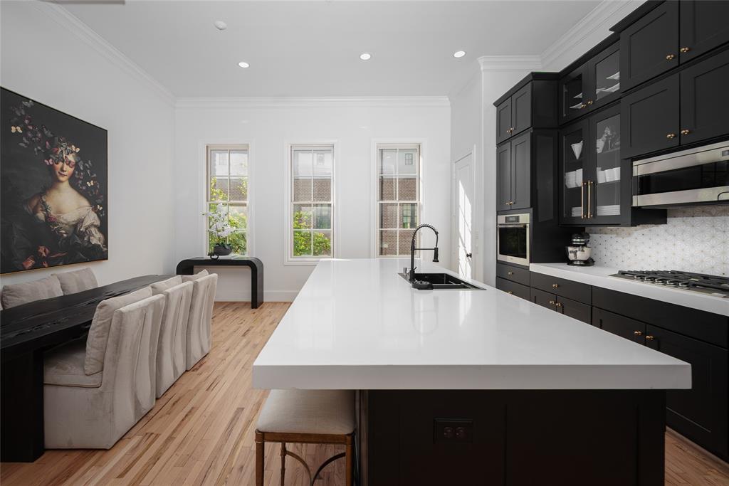 727 Will Rice Avenue Irving, TX 75039 - Photo 6 of 26 a large kitchen with kitchen island a stove a sink a dining table and chairs