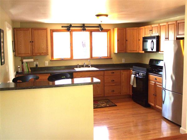 34 Hereford Road Marblehead, MA 01945 - Photo 4 of 9 a kitchen with stainless steel appliances granite countertop a stove a sink and a refrigerator