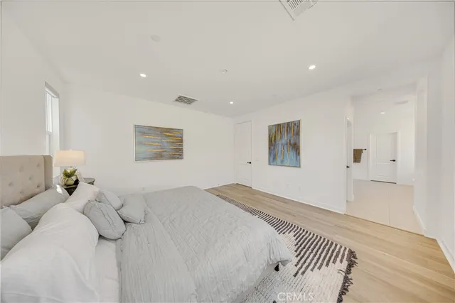 a bedroom with a large bed and a couch