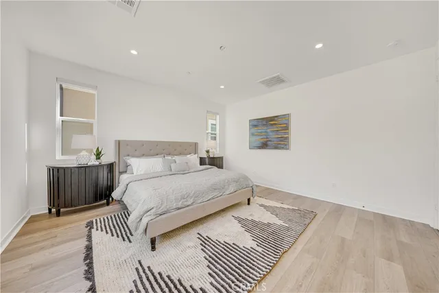 a bedroom with a bed and a night stand