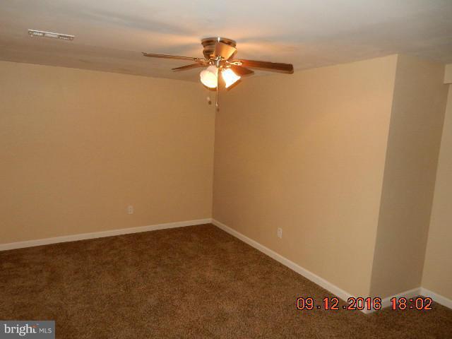 3907 Chaffey Road Randallstown, MD 21133 - Photo 13 of 17 a view of a small space with wooden floor and a fan
