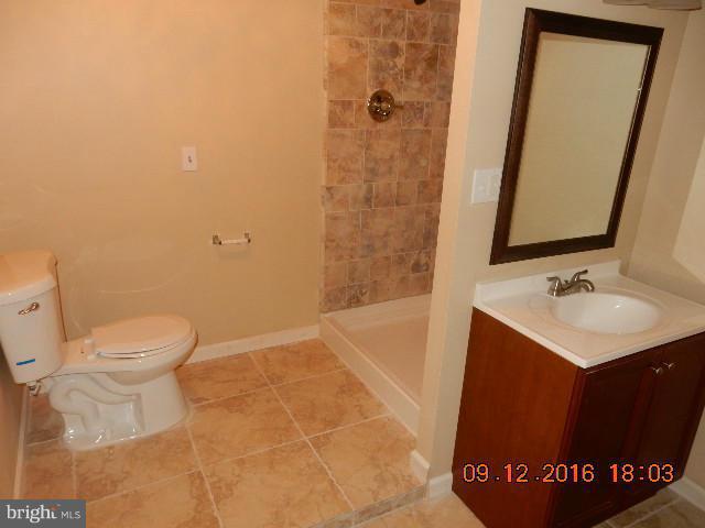 3907 Chaffey Road Randallstown, MD 21133 - Photo 15 of 17 a bathroom with a sink a toilet and shower