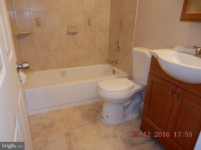 3907 Chaffey Road Randallstown, MD 21133 - Photo 9 of 17 a bathroom with a sink toilet and bathtub