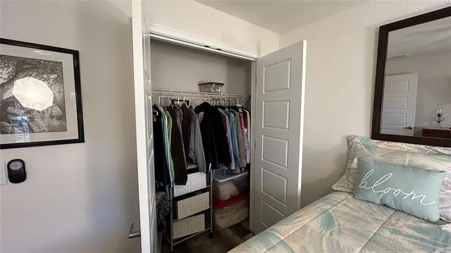 a bed room with a bed and a ceiling fan