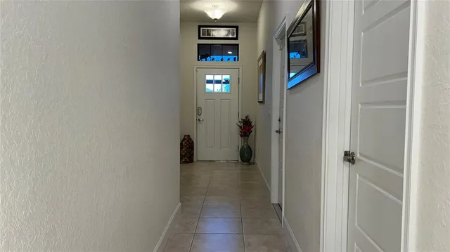 a living room with lots of furniture and kitchen view