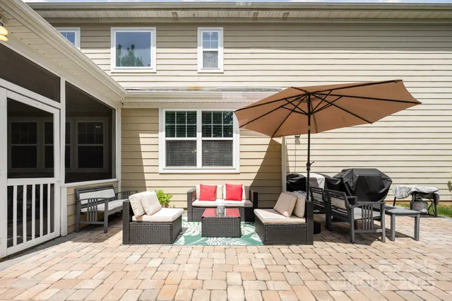 a front view of a house with yard porch and outdoor seating