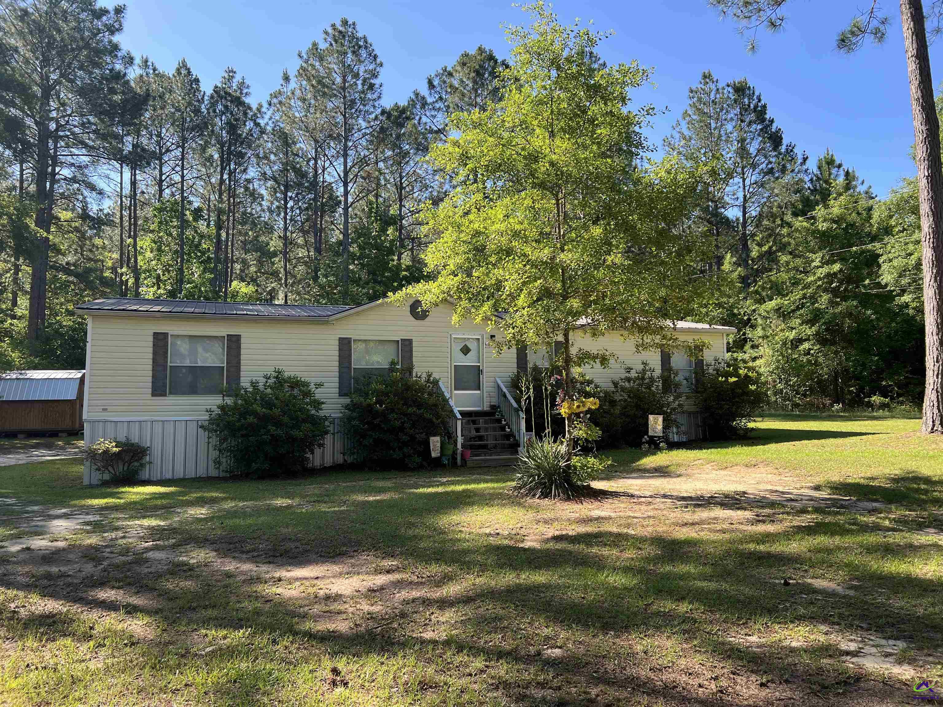 166 Pebble Hills Road Cochran, GA 31014 - Photo 1 of 27 a view of a house with a yard