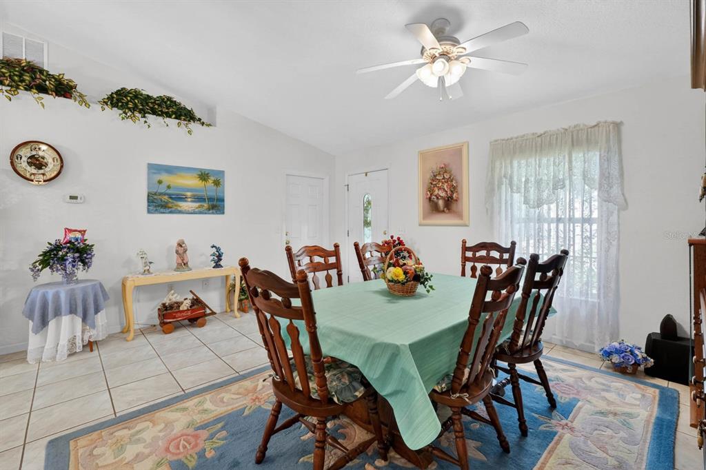 80 Roxboro Drive Palm Coast, FL 32164 - Photo 8 of 39 a view of a dining room with furniture and a chandelier