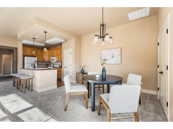 a kitchen with kitchen island granite countertop a sink appliances cabinets and a counter top space