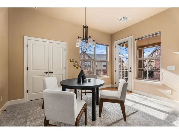 a living room with furniture a chandelier and a dining table