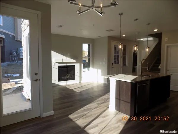 a view of living room and kitchen with wooden floor