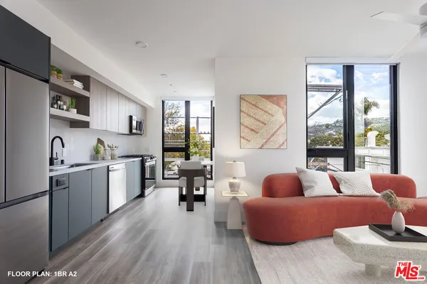 a living room with furniture and a large window