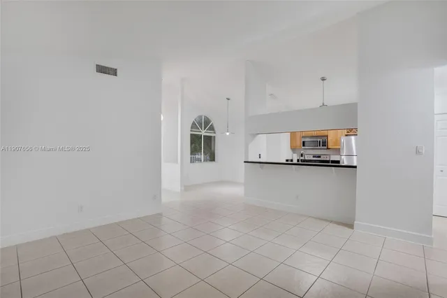 a view of kitchen with white cabinets