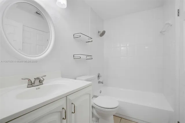 a bathroom with a sink toilet and a mirror