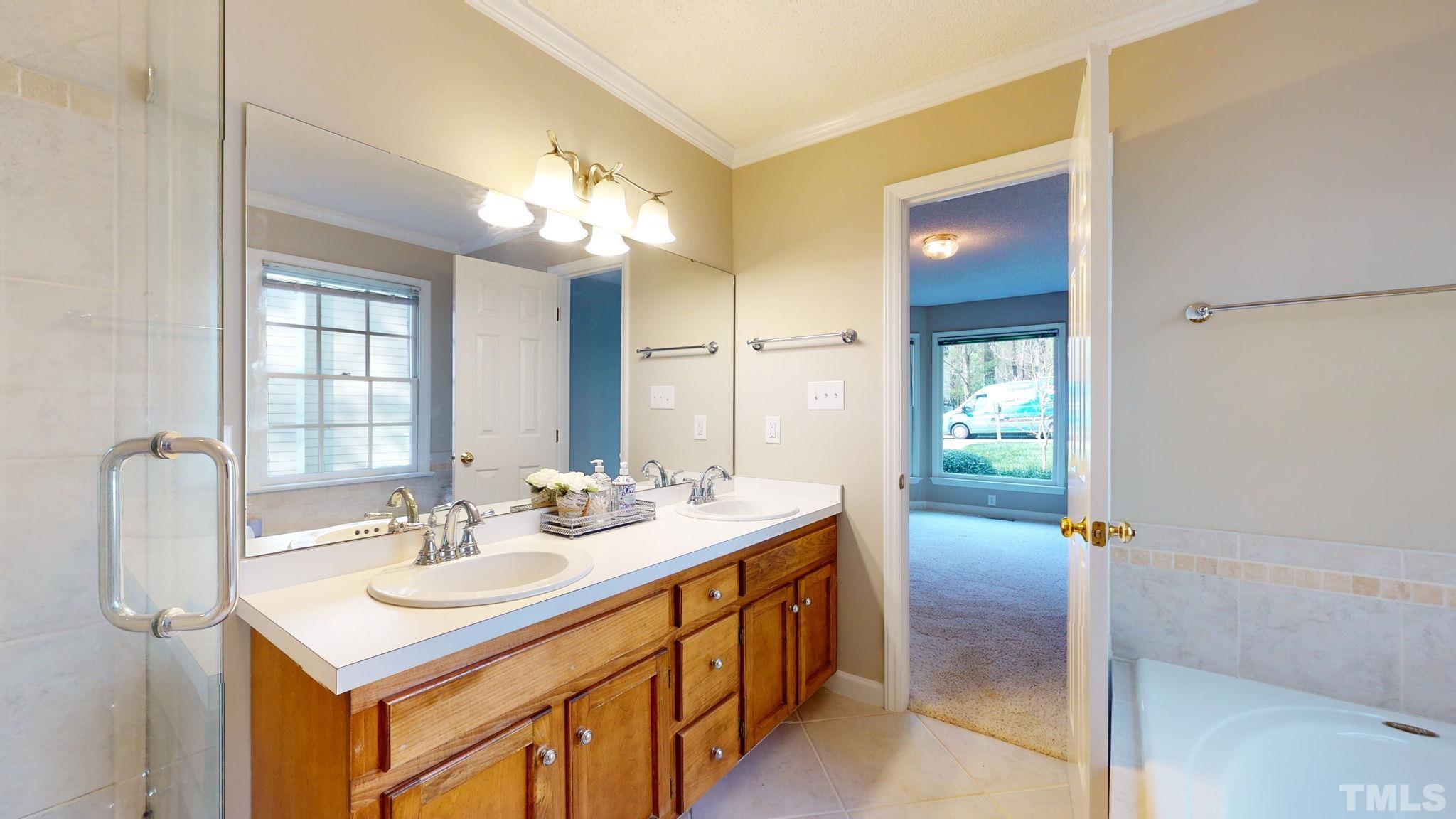 213 Silvercliff Trail Cary, NC 27513 - Photo 13 of 31 a bathroom with a sink double vanity and a mirror