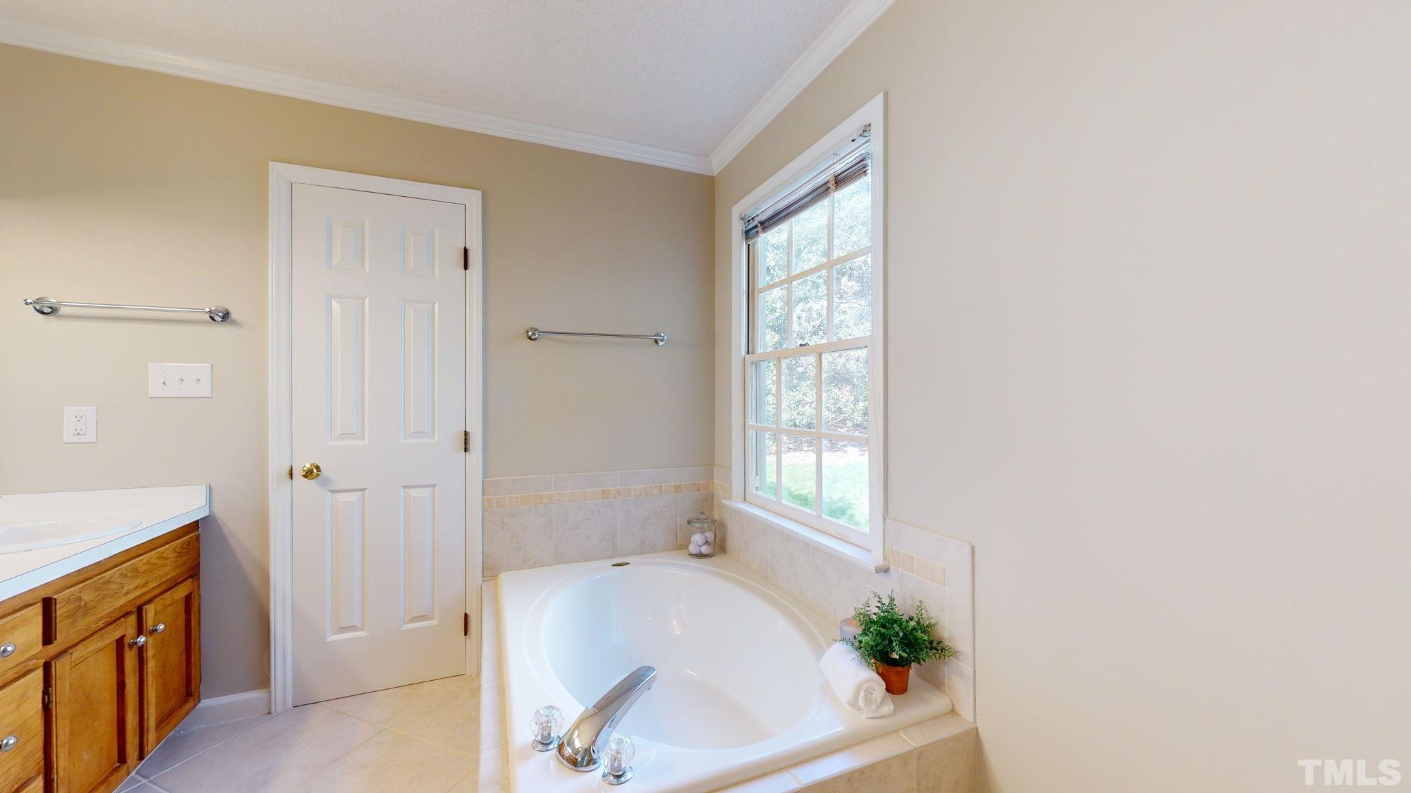 213 Silvercliff Trail Cary, NC 27513 - Photo 14 of 31 a bathroom with a tub sink and mirror