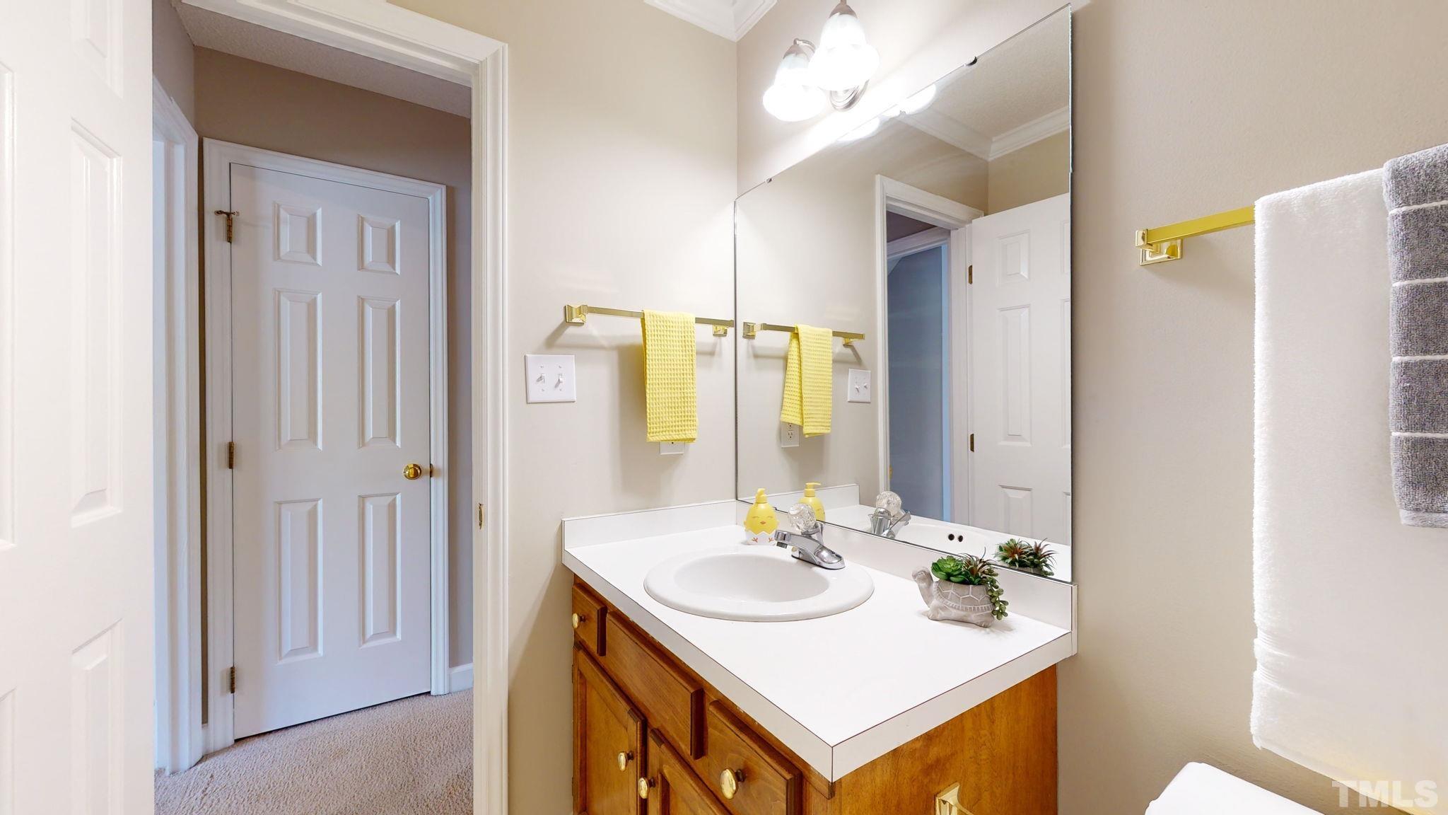 213 Silvercliff Trail Cary, NC 27513 - Photo 20 of 31 a bathroom with a sink and a mirror