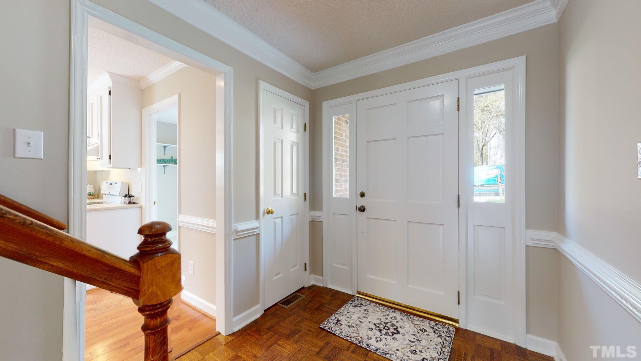 213 Silvercliff Trail Cary, NC 27513 - Photo 23 of 31 a view of a hallway with entryway wooden floor and front door