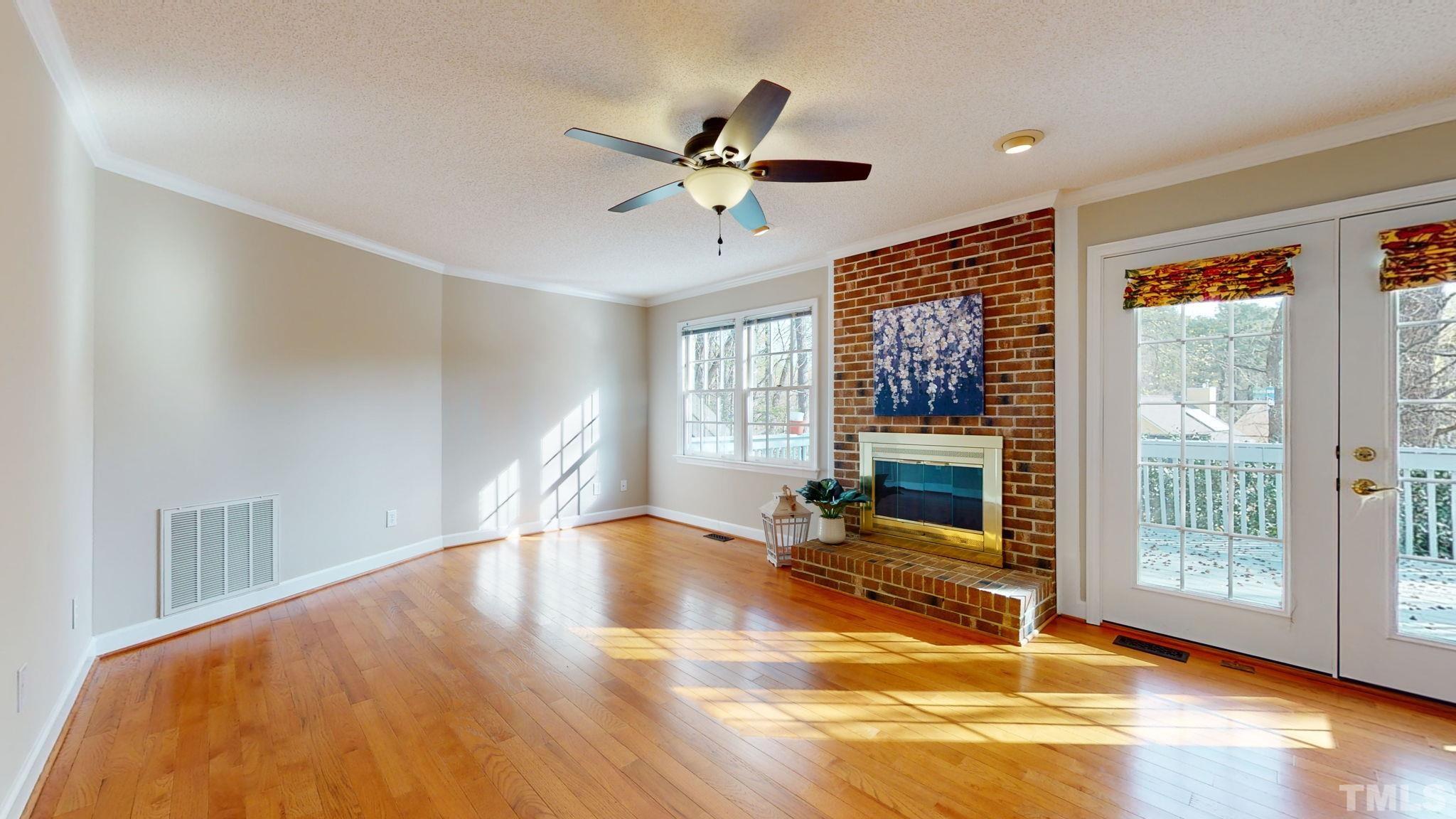 213 Silvercliff Trail Cary, NC 27513 - Photo 24 of 31 a view of empty room with wooden floor and fan