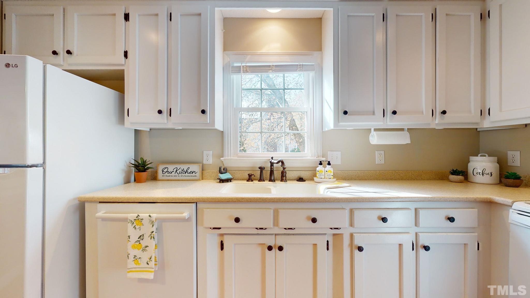 213 Silvercliff Trail Cary, NC 27513 - Photo 8 of 31 a kitchen with a sink cabinets and a window