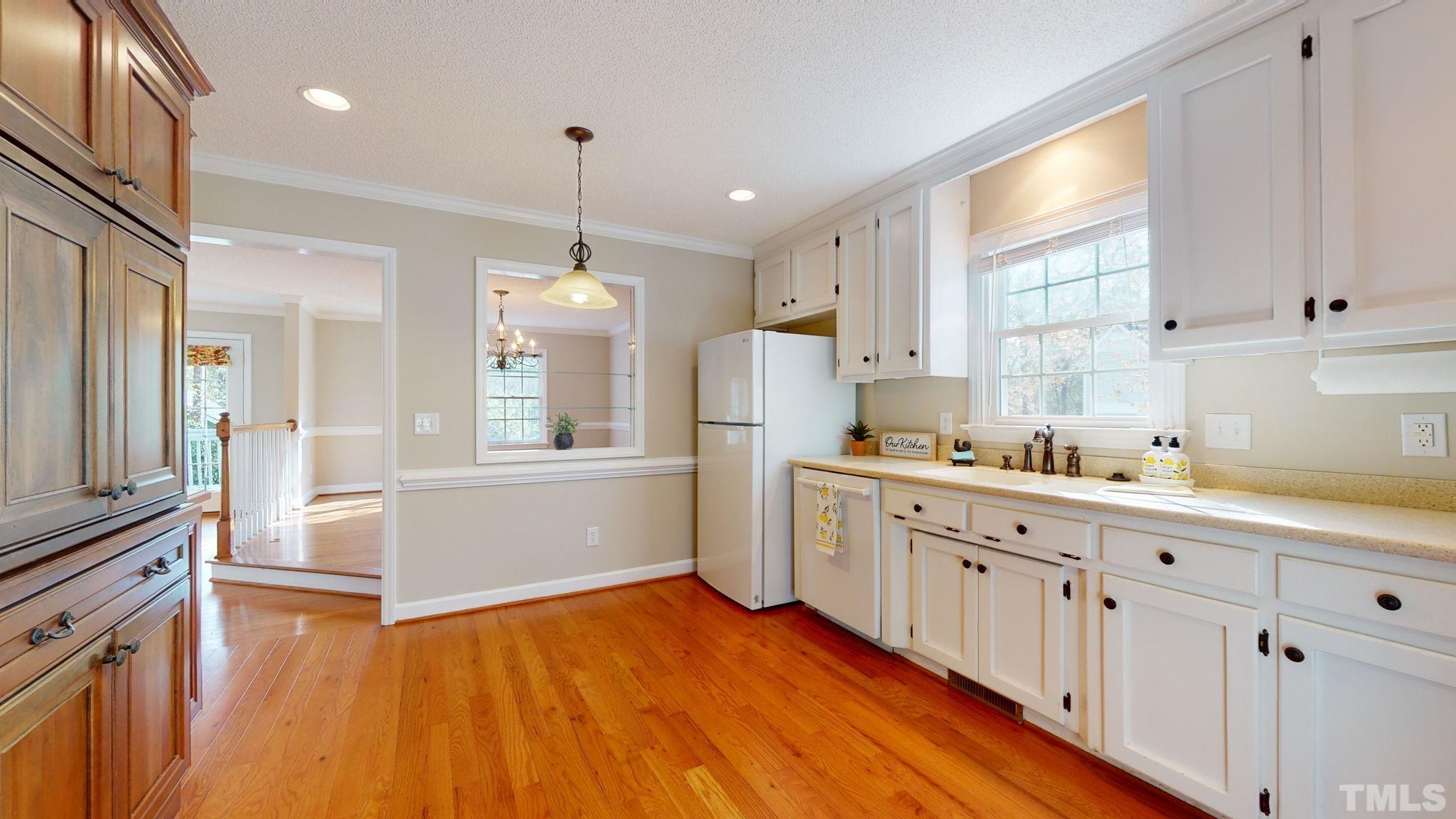 213 Silvercliff Trail Cary, NC 27513 - Photo 9 of 31 a kitchen with cabinets a sink and appliances