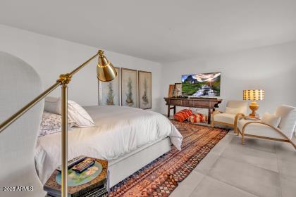 7614 East Gila Bend Road Scottsdale, AZ 85258 - Photo 12 of 36 a bed room with a bed and a chair