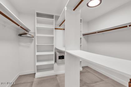 7614 East Gila Bend Road Scottsdale, AZ 85258 - Photo 16 of 36 a view of walk in closet with empty racks