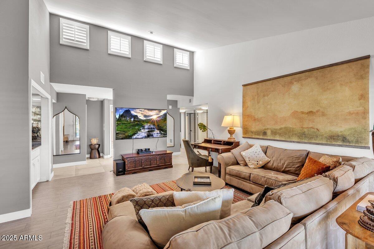 7614 East Gila Bend Road Scottsdale, AZ 85258 - Photo 2 of 36 a living room with furniture and a flat screen tv