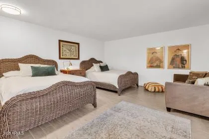 a spacious bedroom with two beds and a couch