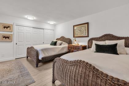 7614 East Gila Bend Road Scottsdale, AZ 85258 - Photo 22 of 36 a bedroom with two beds and a painting on the wall