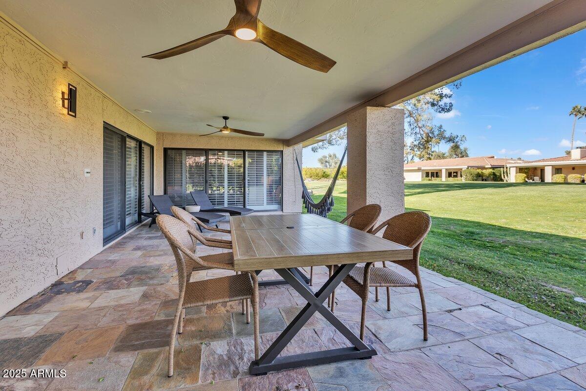 7614 East Gila Bend Road Scottsdale, AZ 85258 - Photo 25 of 36 a view of a dining room with furniture window and wooden floor