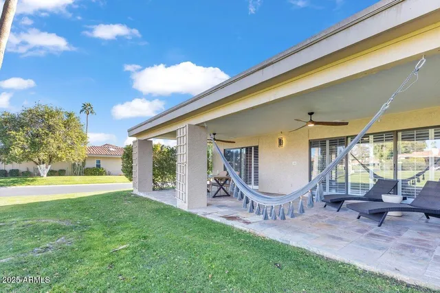 a view of a house with backyard porch and sitting area