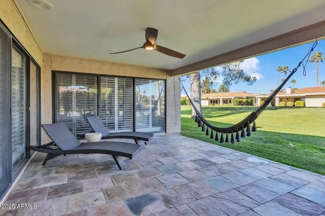 a view of a swimming pool with lounge chair in front of city