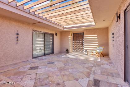 7614 East Gila Bend Road Scottsdale, AZ 85258 - Photo 30 of 36 a view of an empty room with a fireplace and a window