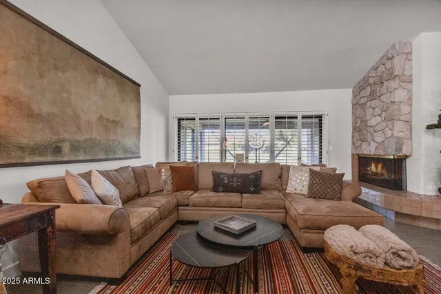 a living room with furniture and a fireplace
