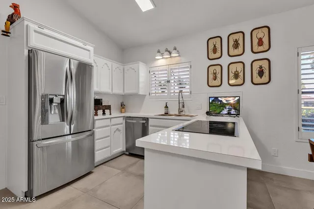 a kitchen with a refrigerator and a sink